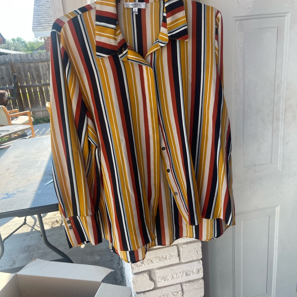 This a button down striped blouse, multiple colors.